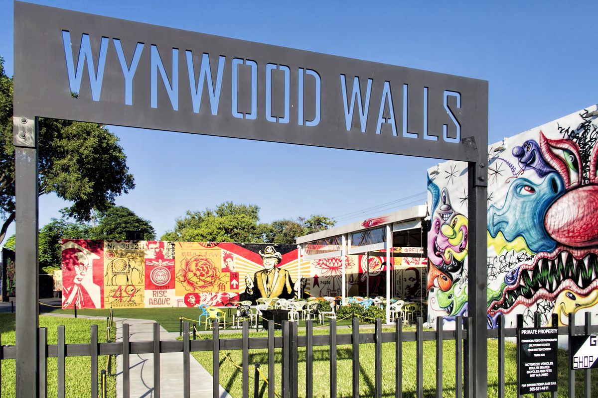 The Wynwood Walls sign with colorful murals behind it.