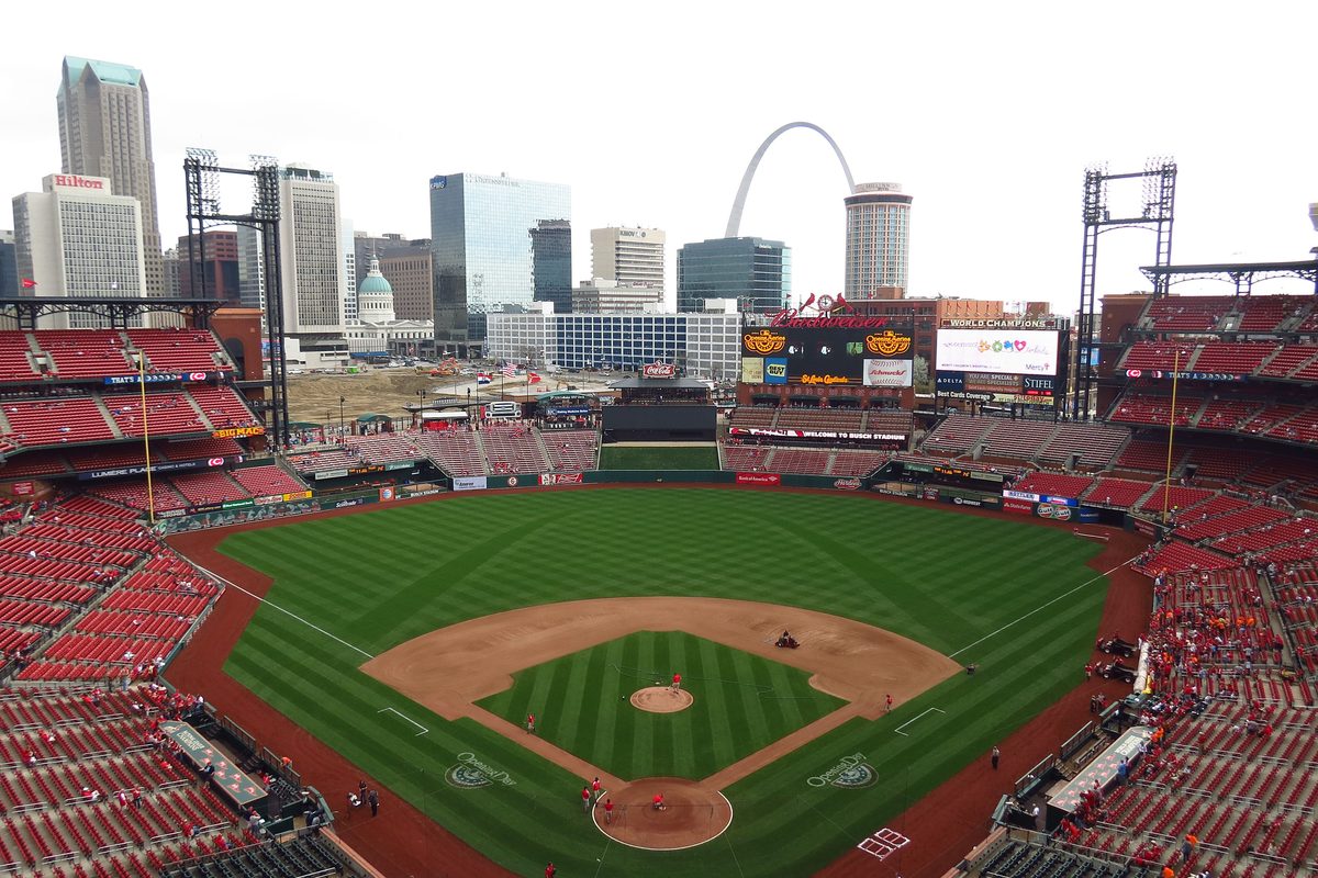 The field and seating at Busch Stadium, with the downtown skyline and the Gateway Arch beyond.
