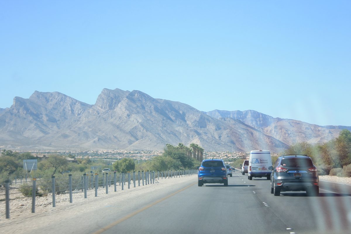 A road in Summerlin with the Red Rock Canyon mountains behind it.
