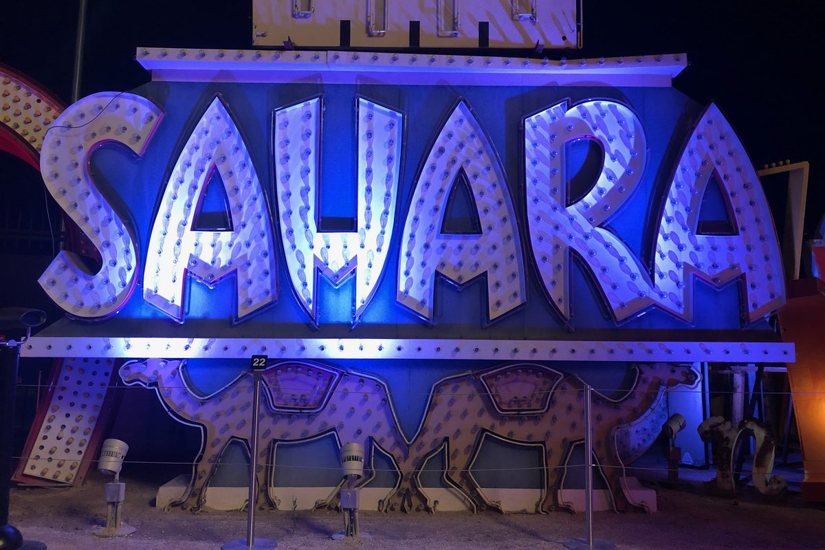 The lit-up Sahara sign among vintage signs at the Neon Museum.