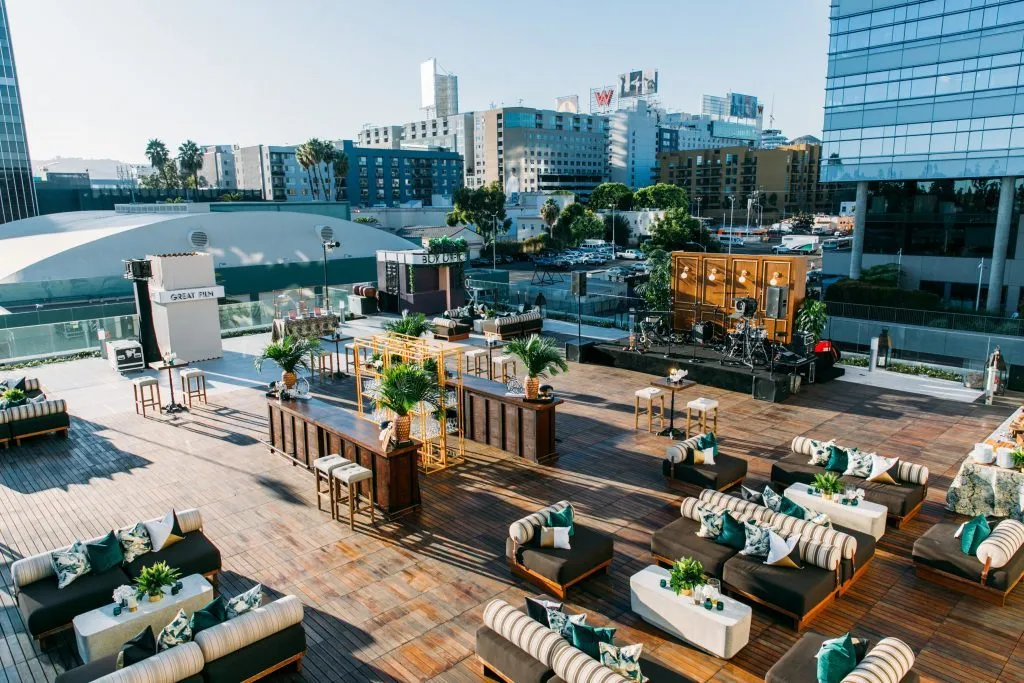 Rooftop lounge seating arranged on a terrace above a city skyline
