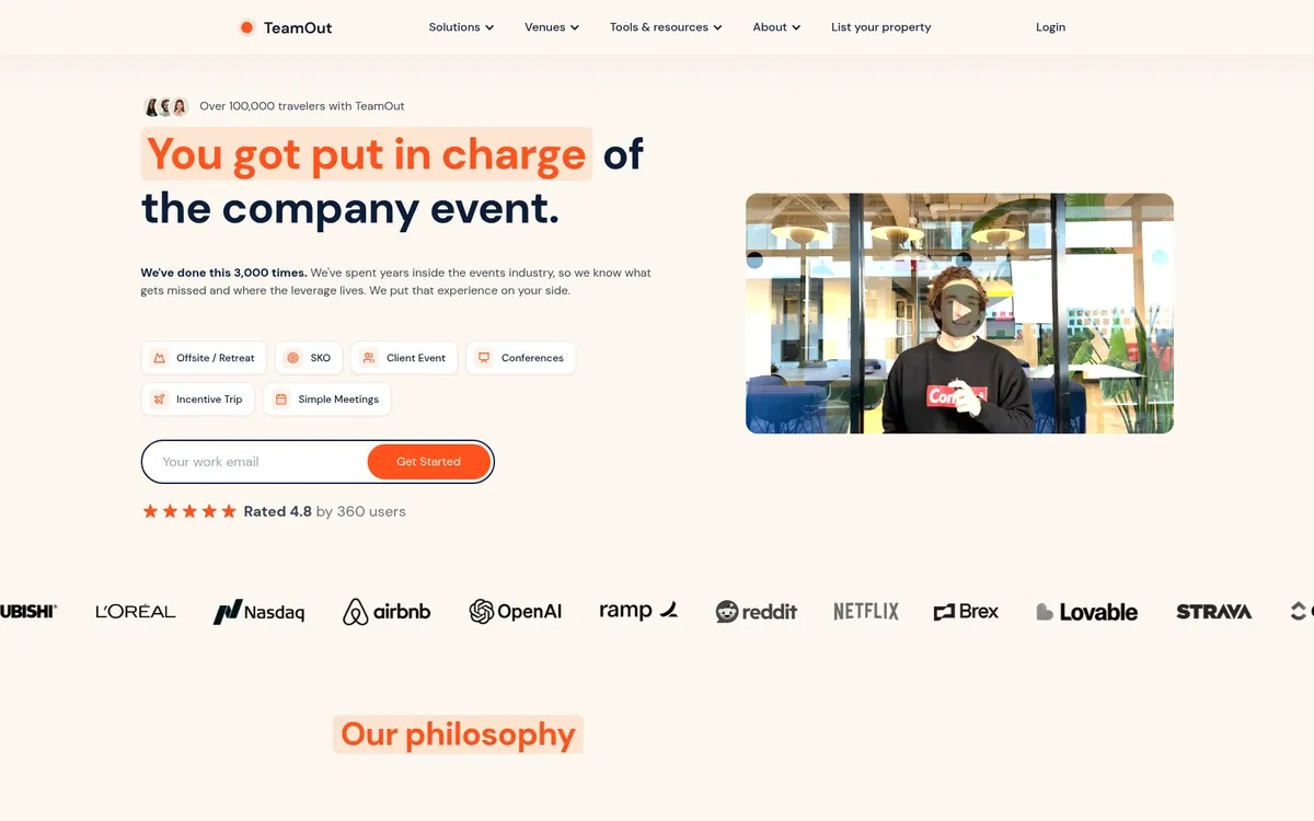 The TeamOut homepage shows the headline "You got put in charge of the company event.", with the first words highlighted in orange, above event-type buttons, a work-email field and a rating line. On the right is a video thumbnail of a person in a dark sweatshirt in a bright office with a play button, and a row of customer logos and an "Our philosophy" heading sit below.
