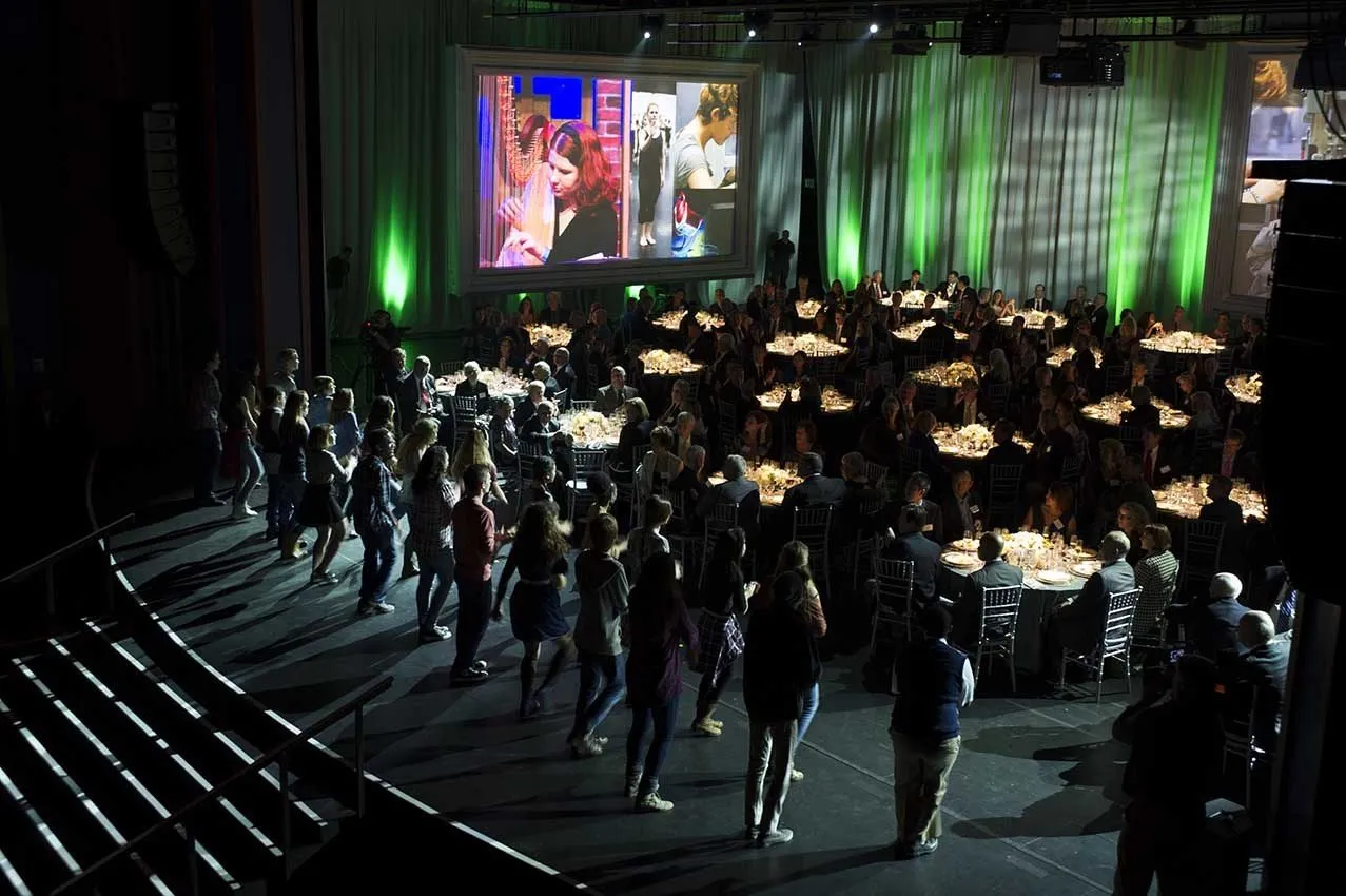 Evening dinner room with a stage performance and green lighting
