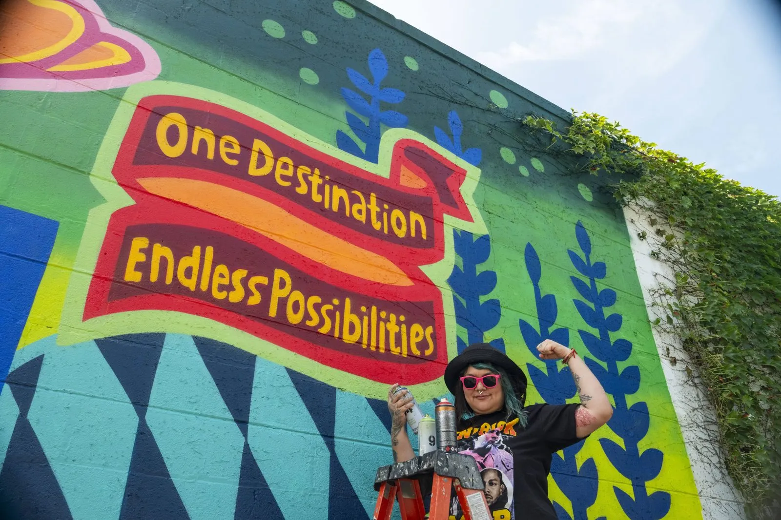 Painted outdoor mural reading One Destination Endless Possibilities at a brand campaign