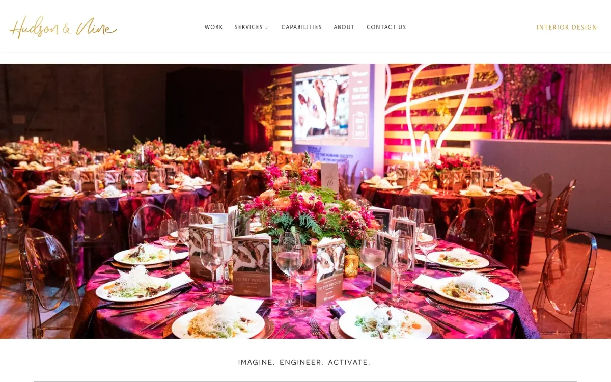 Hudson & Nine homepage with a gold script wordmark above a photo of a gala dinner with pink floral centerpieces, plated meals, clear chairs and a neon-lit stage screen, and the tagline Imagine. Engineer. Activate.