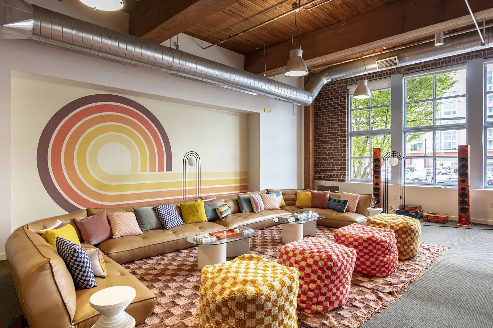 Coworking lounge with a sunset mural at the Stellar Development Foundation offsite space