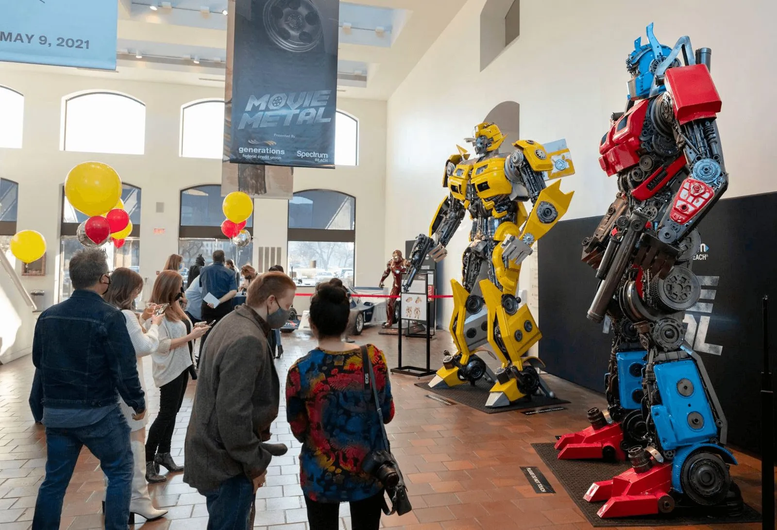 Large character figure standing among guests at an event activation