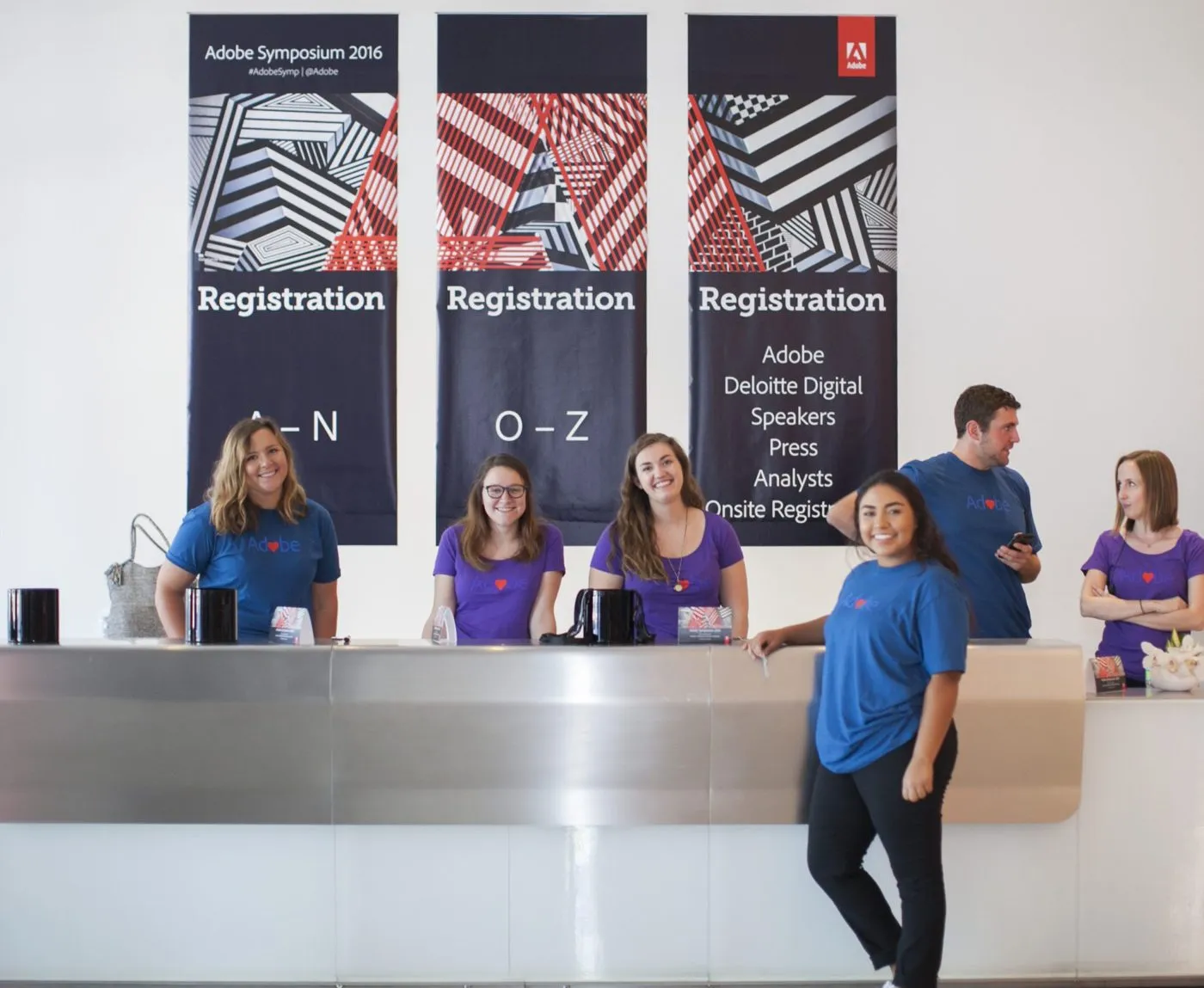 Registration desk with printed banners and staff at a conference