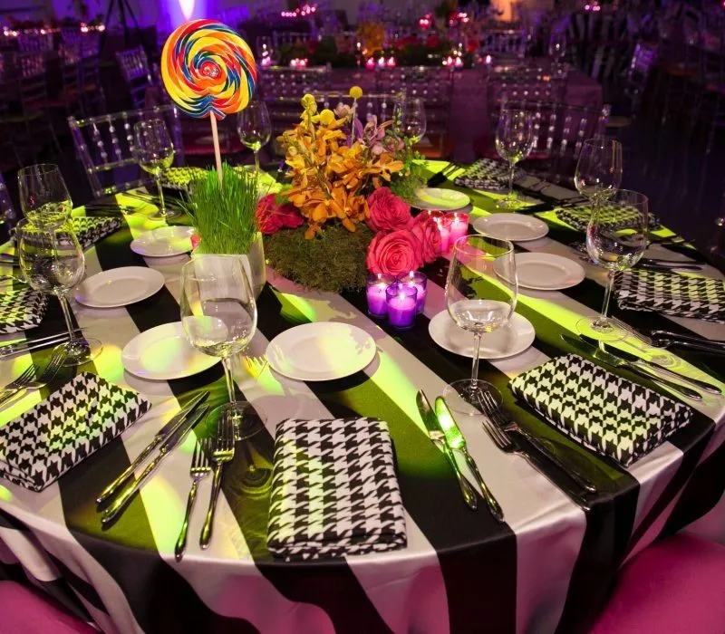 Round dinner table with patterned linens and colorful centerpieces