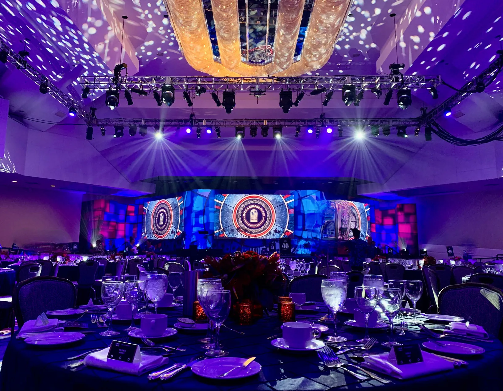 Gala dinner ballroom with LED screens, gobo lighting and a chandelier