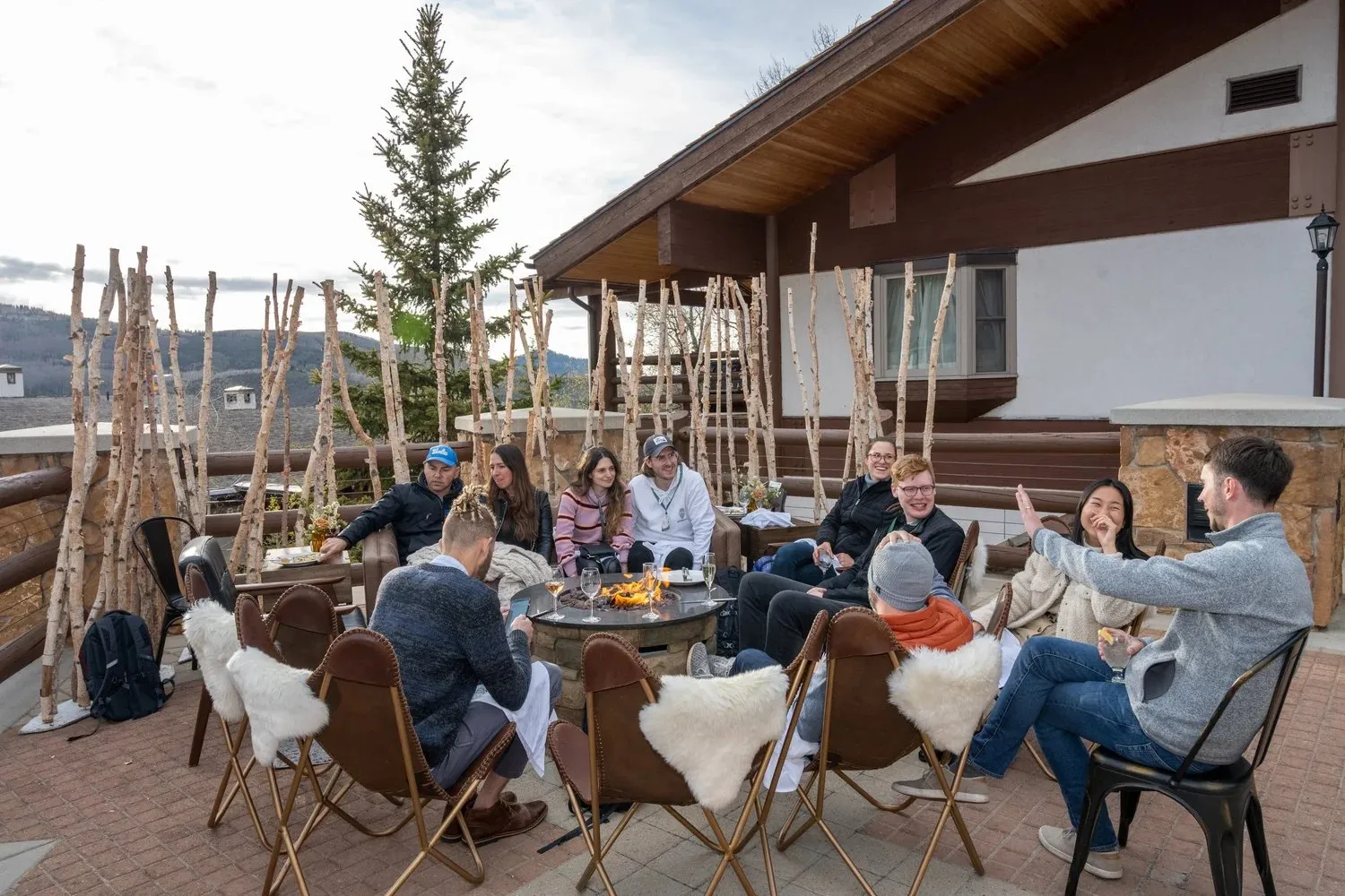 Retreat attendees gathered around a fire pit on a Park City patio