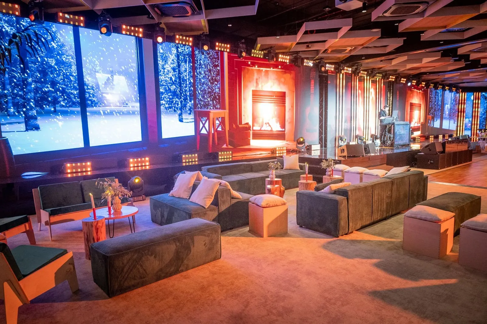 Lounge seating in front of winter-scene LED walls at a company event in Poland