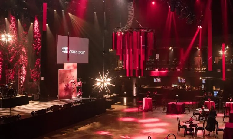 Stage with red lighting and decor set for a corporate holiday party
