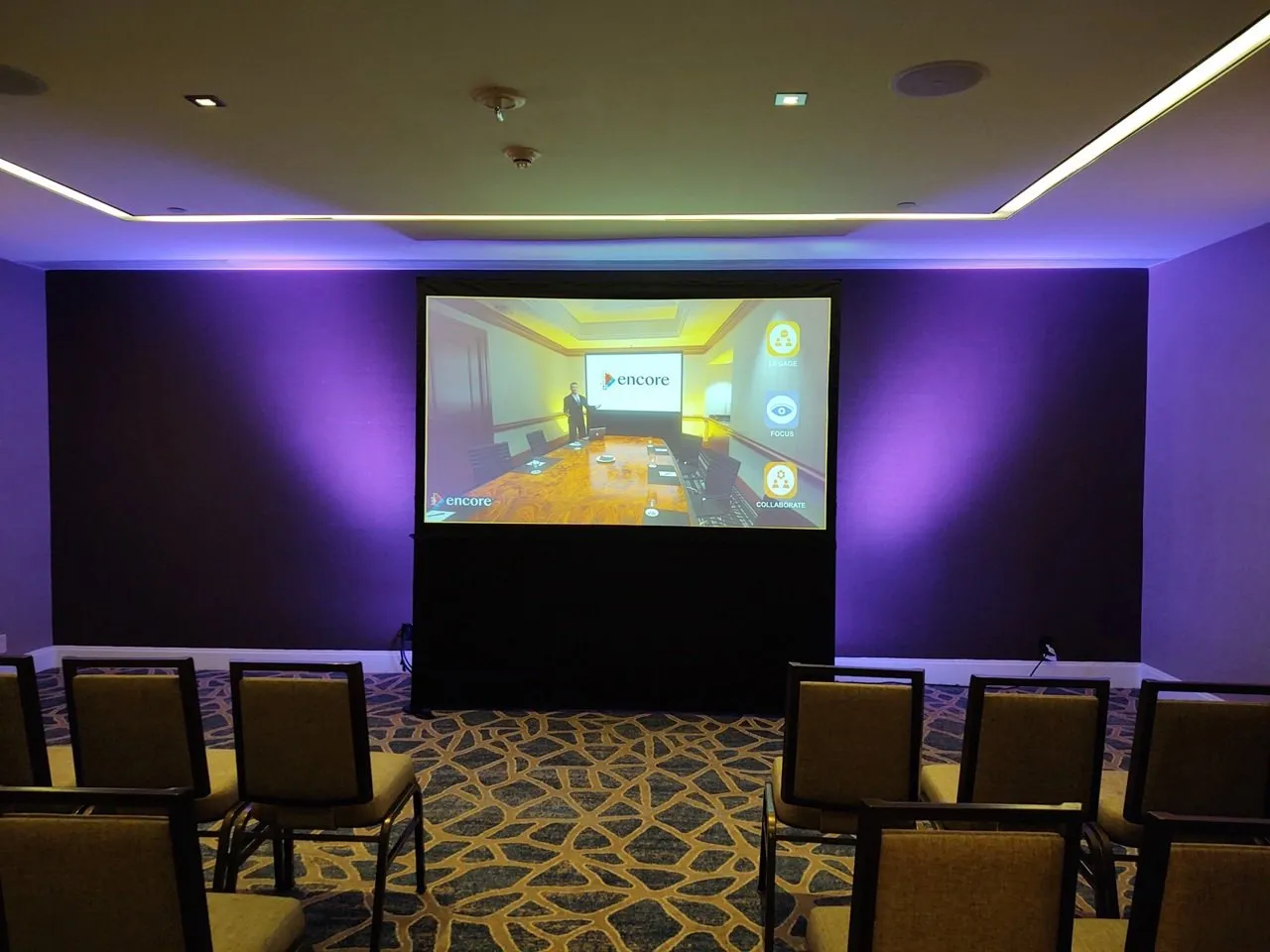 Meeting room with a projection screen and purple lighting