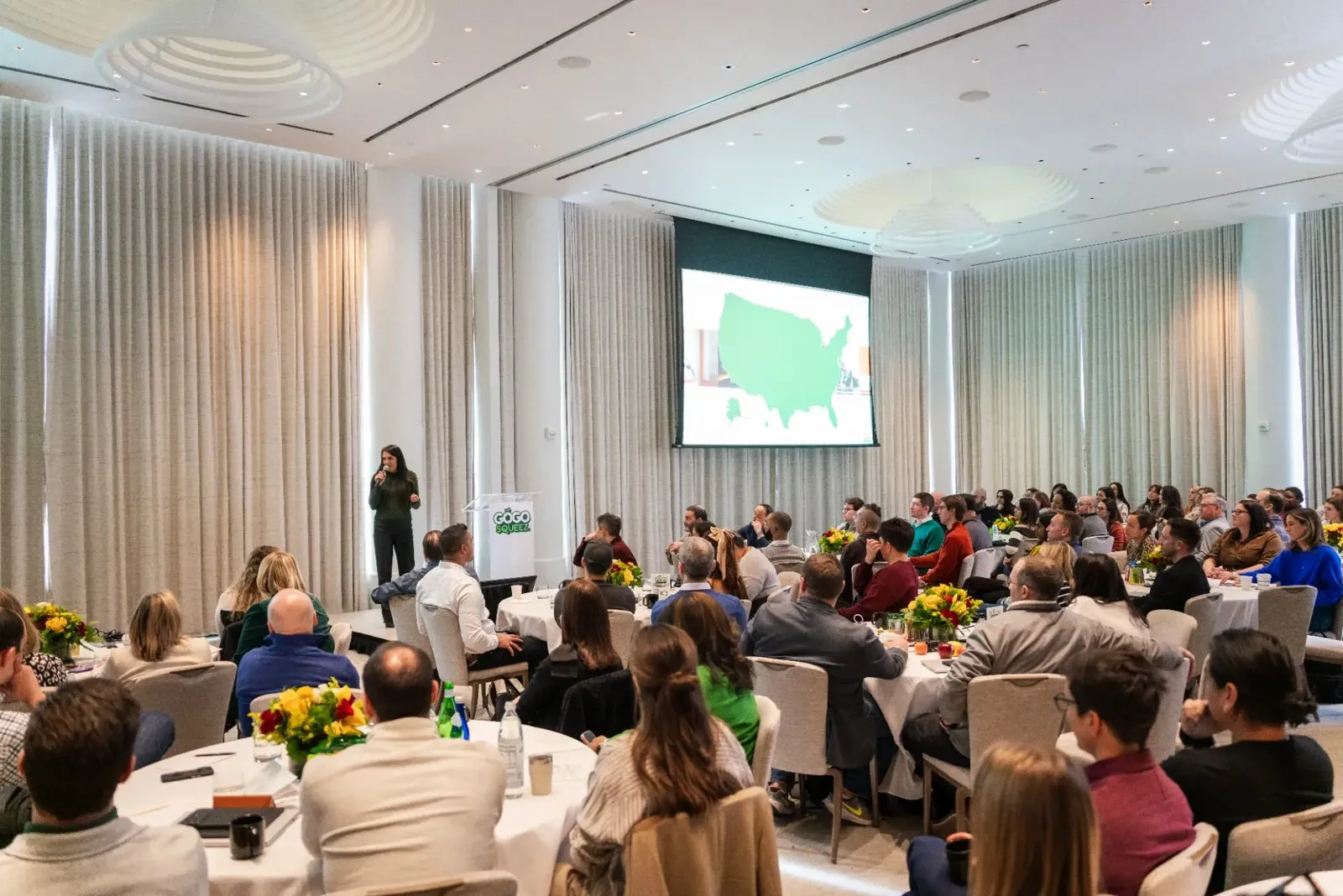 Speaker presenting to a seated conference audience