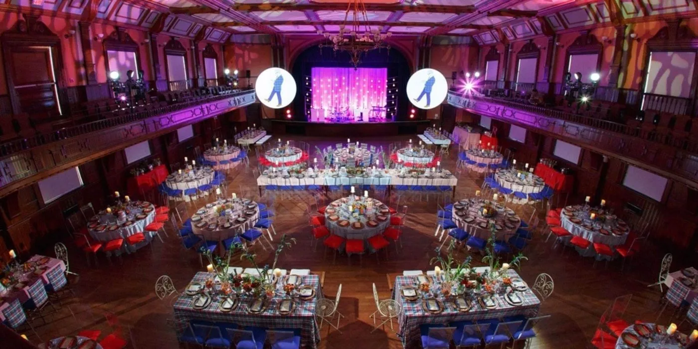 Historic hall set with banquet tables and projected branding