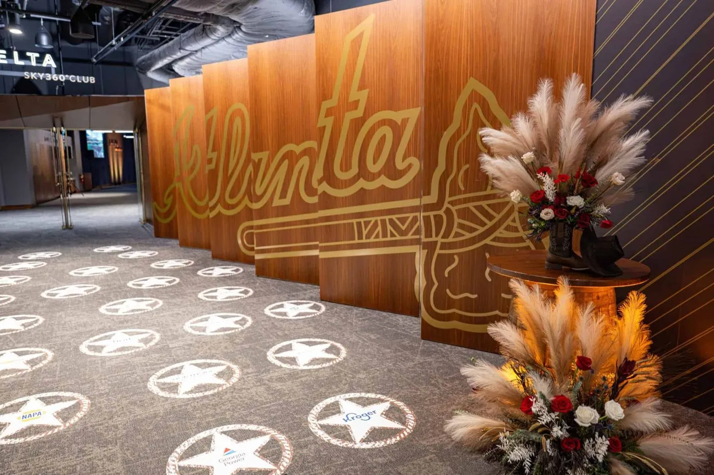 Branded entrance corridor with floral arrangements at a company event