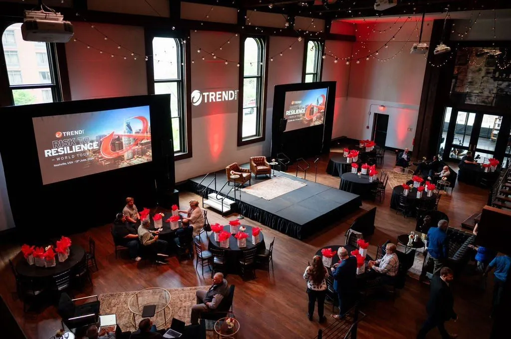 Corporate conference with a central stage and large presentation screens