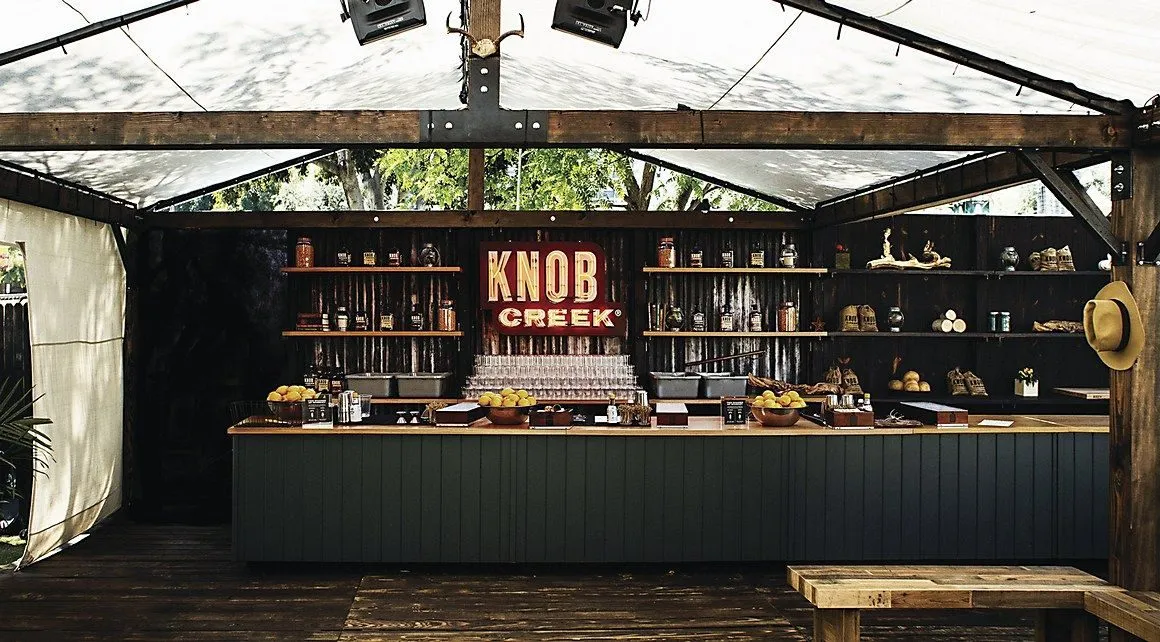 Pop-up bar and shop in a glass-walled tent