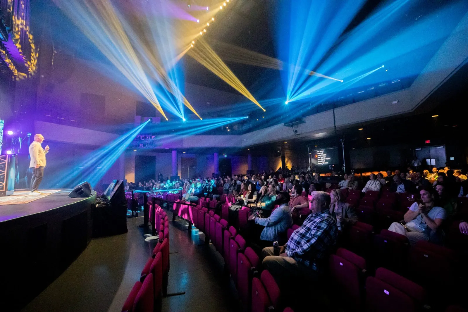 Blackbaud Sales Kickoff general session with stage lighting and a seated audience