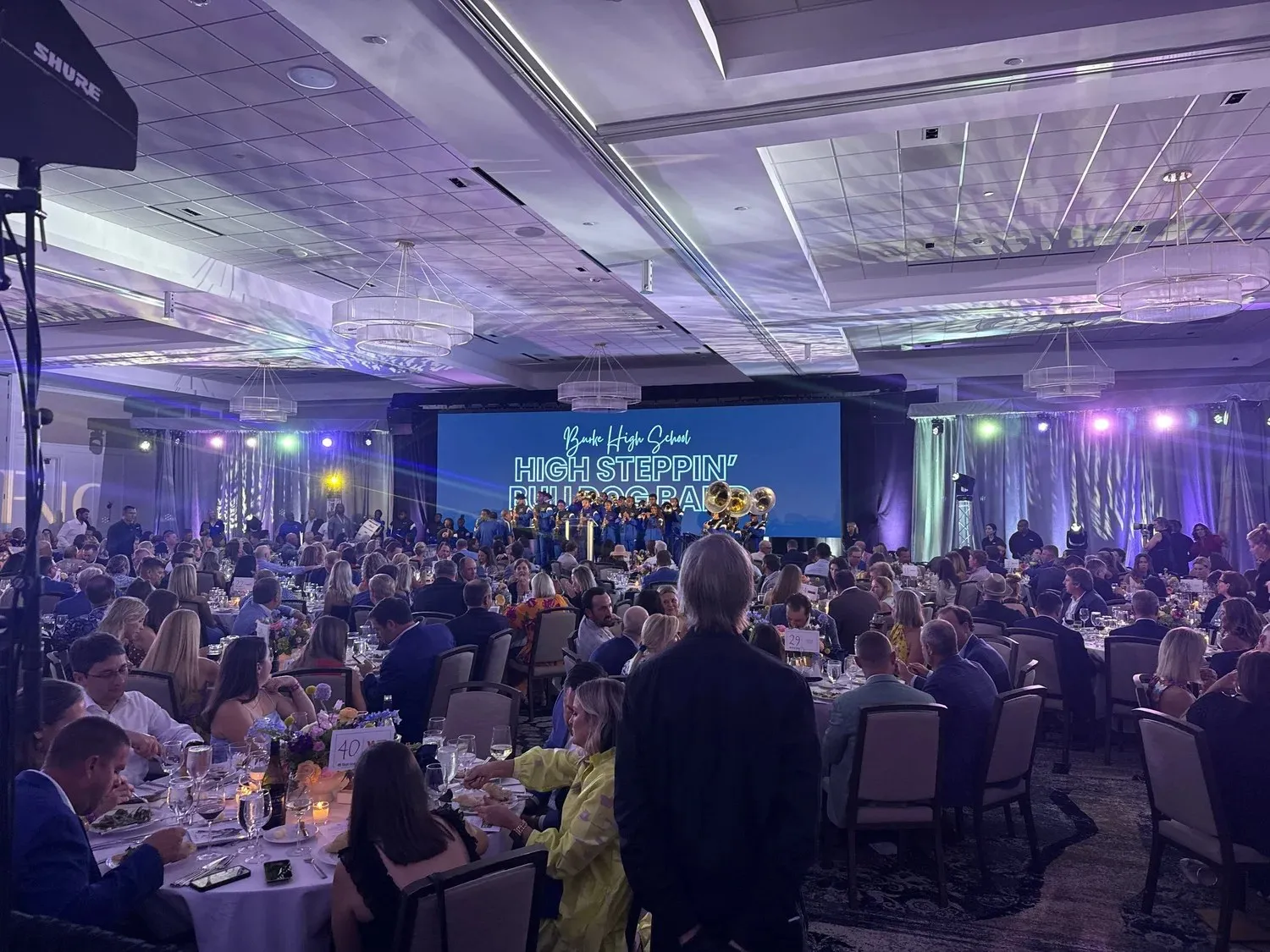 Full general session audience facing an LED stage