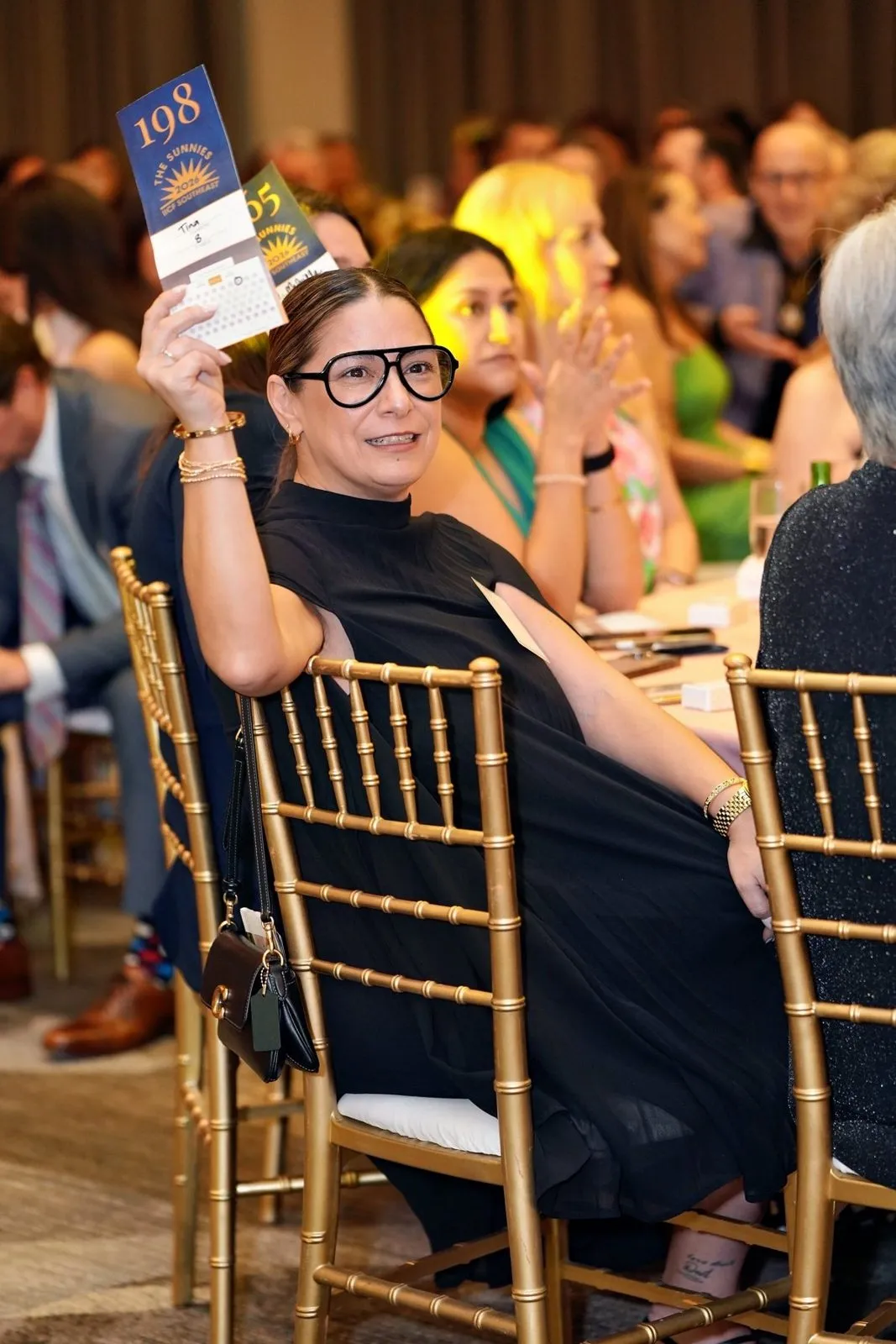 Guests seated and applauding at a corporate event