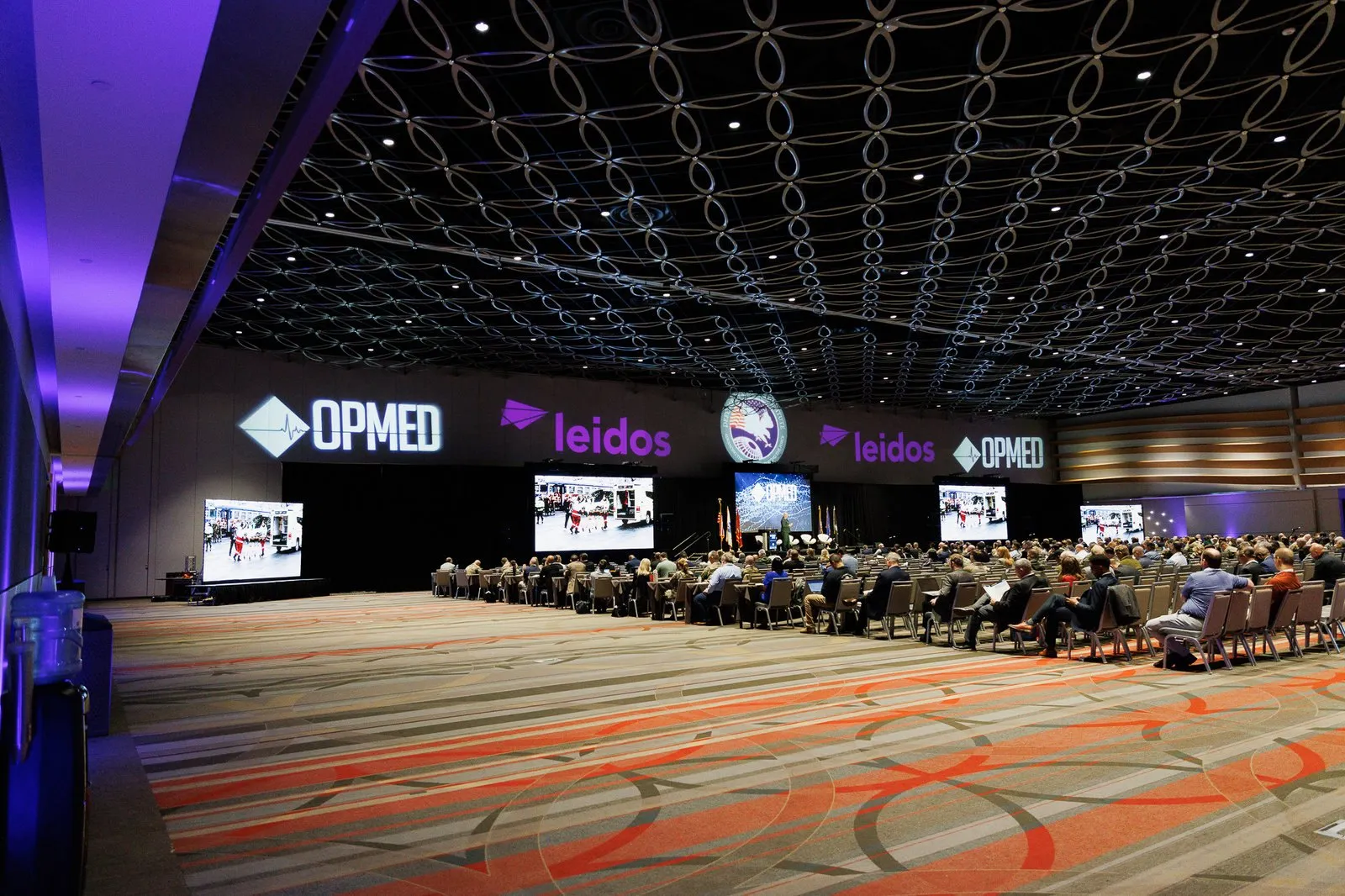 OPMED 2026 general session with LED walls and branded screens in San Antonio