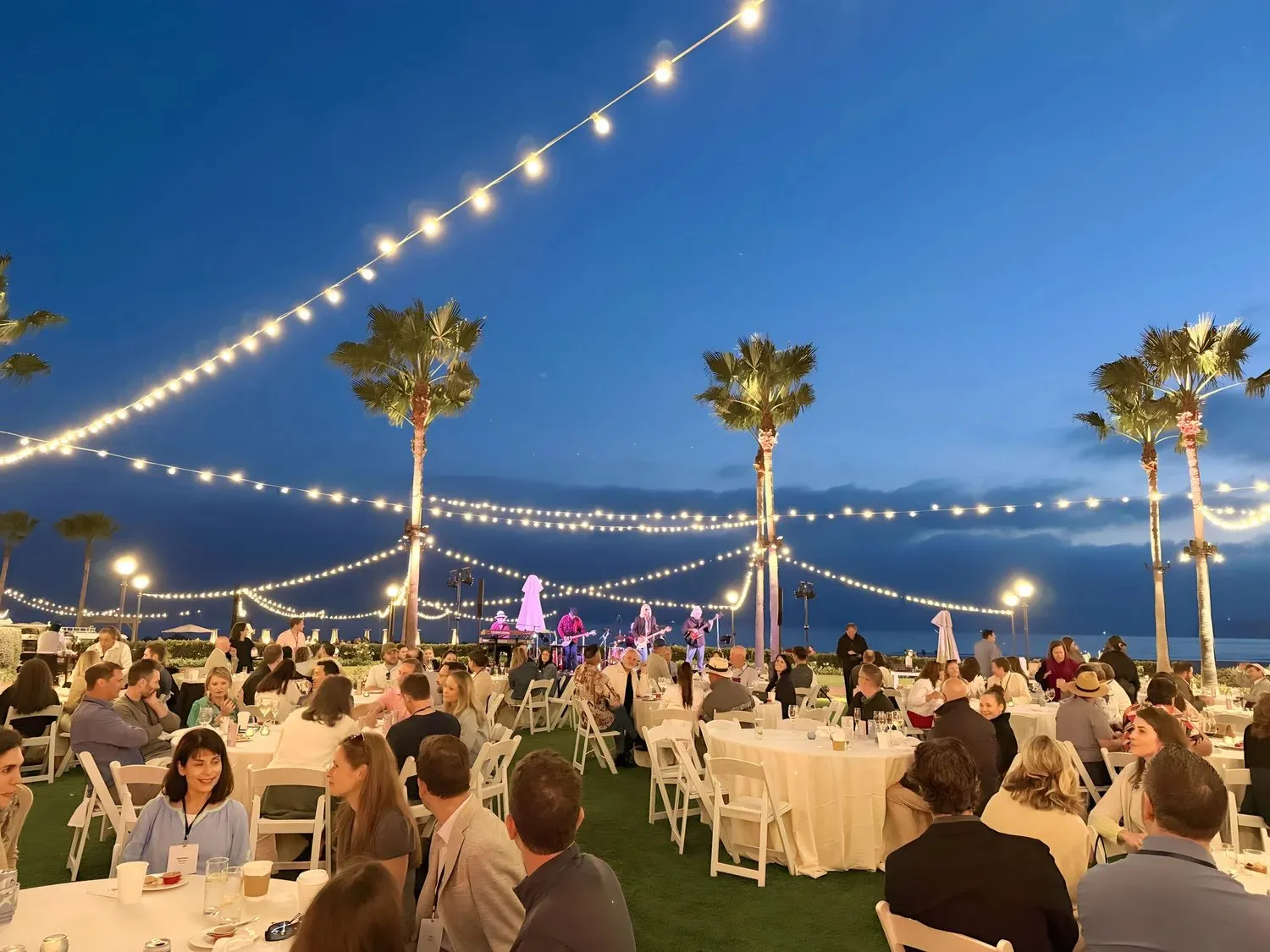 Evening dinner under string lights at a Coronado law firm retreat