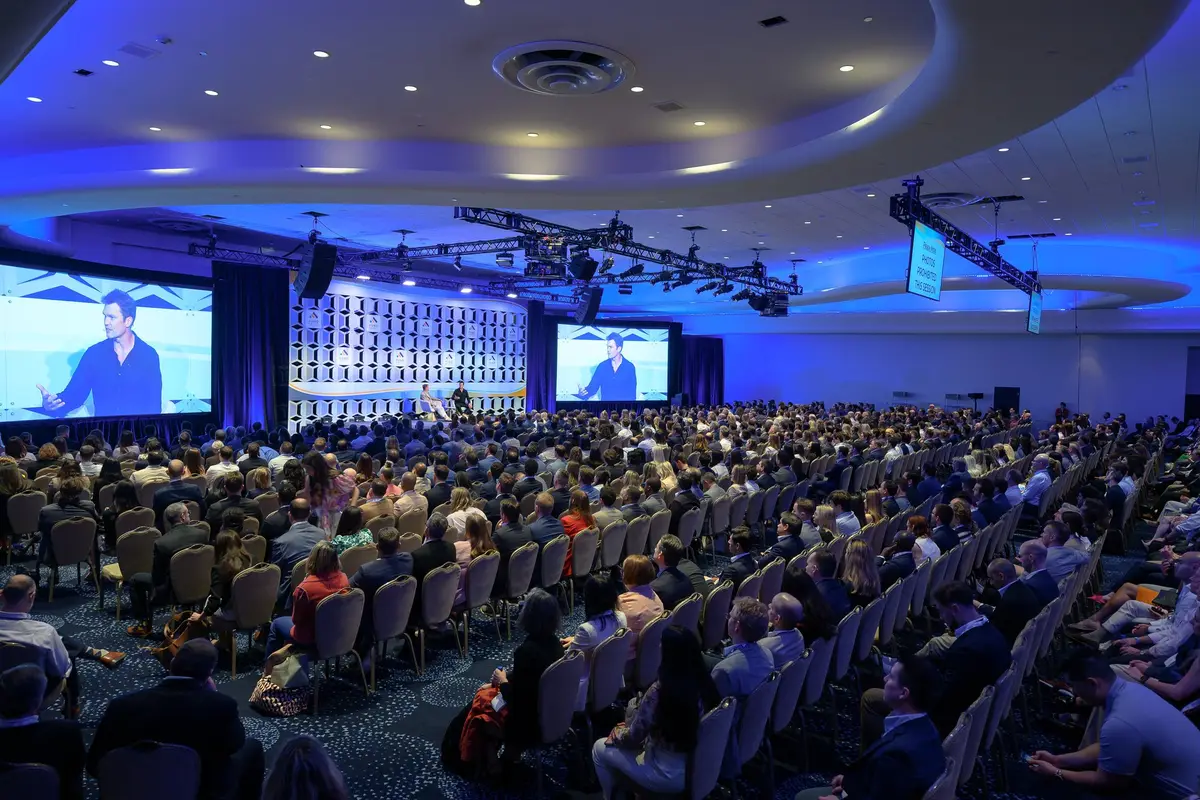 Large conference general session with stage screens