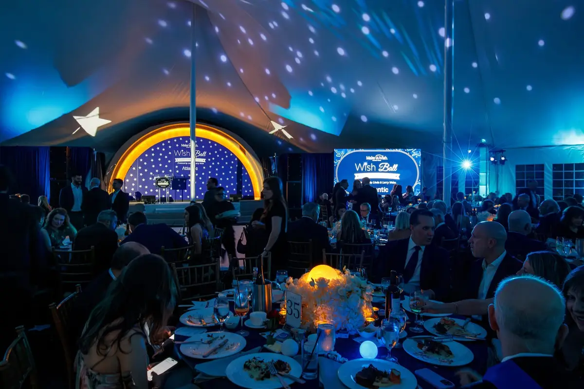 Evening dinner under a tent lit in blue