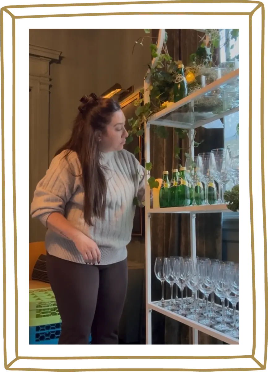 Team member styling glassware shelves during a Perrier activation setup
