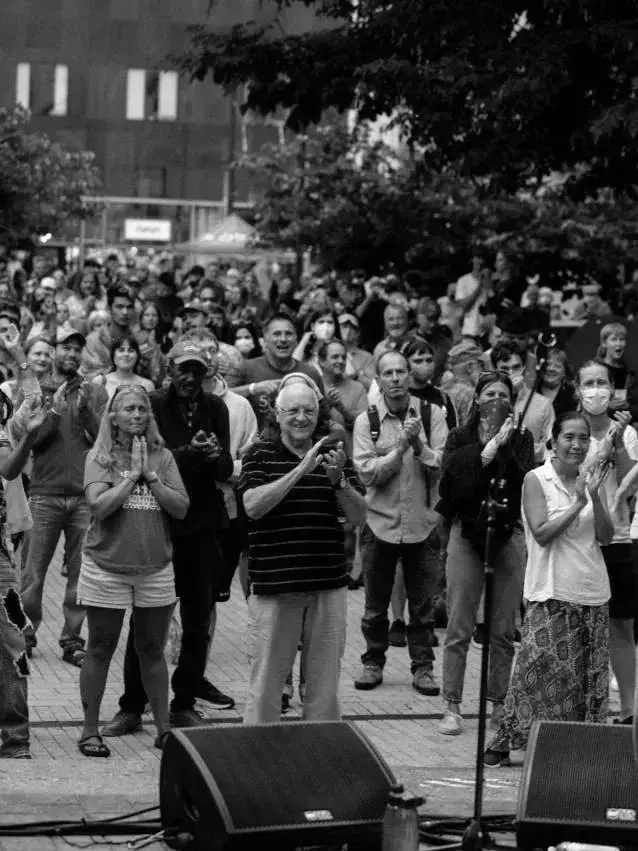 Crowd gathered at an outdoor downtown community event