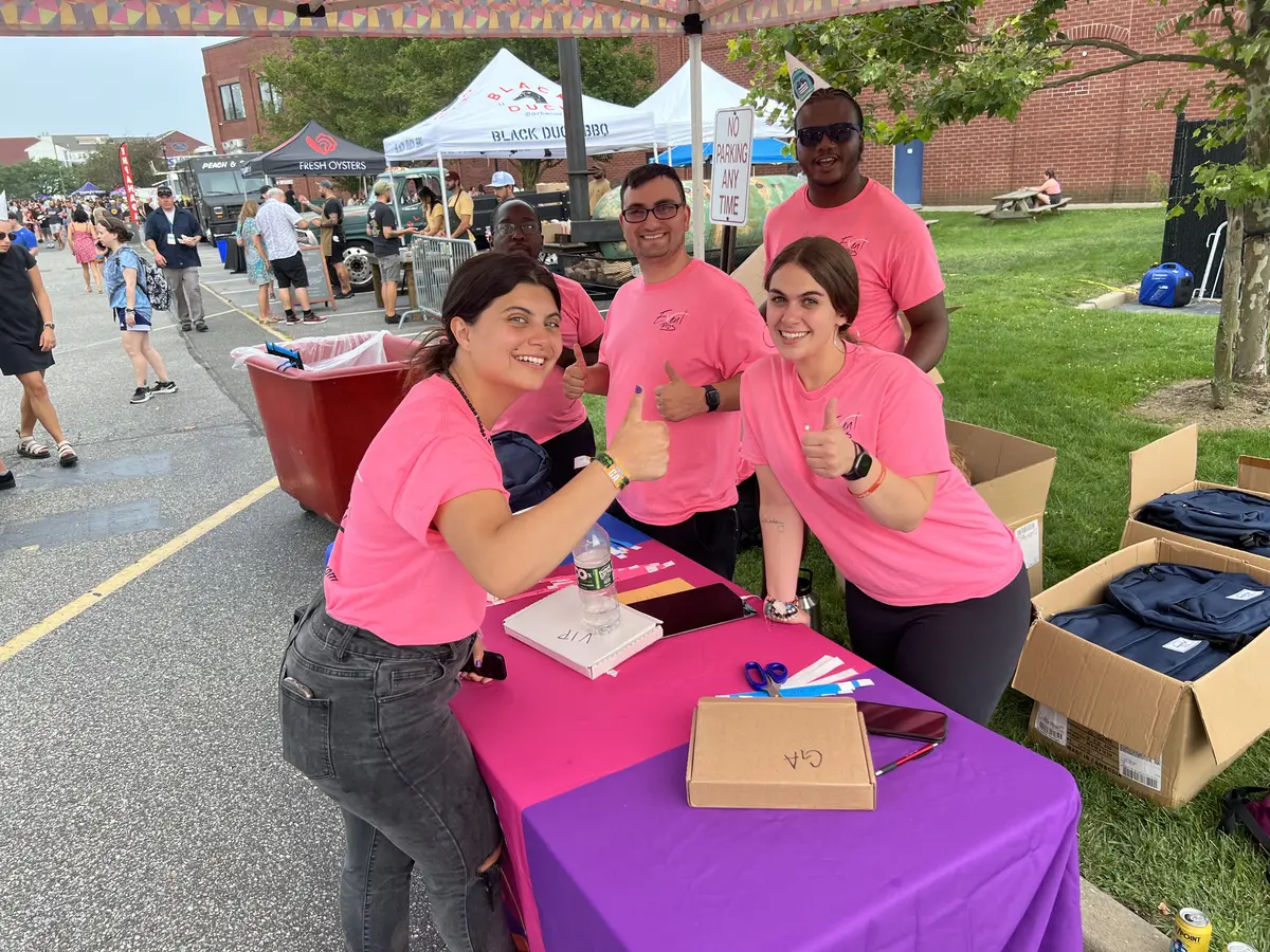 Event staff at an outdoor check-in table