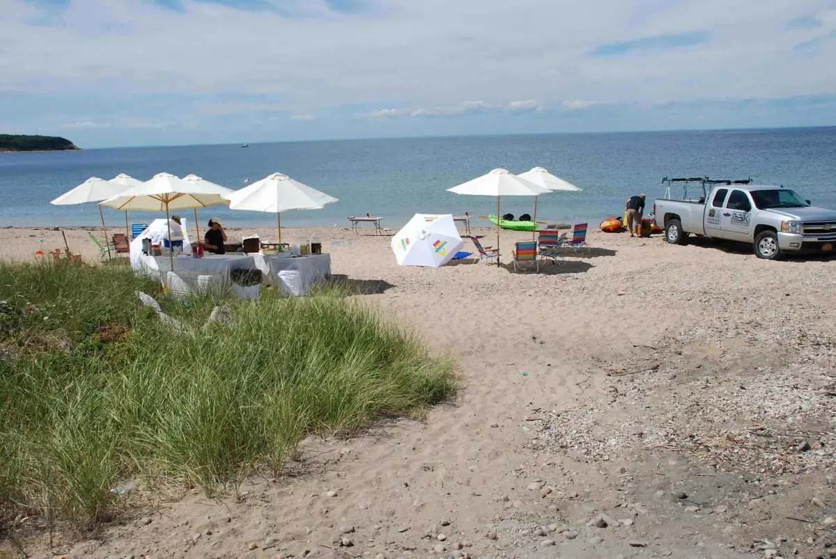 Beach event setup with umbrellas in the Hamptons