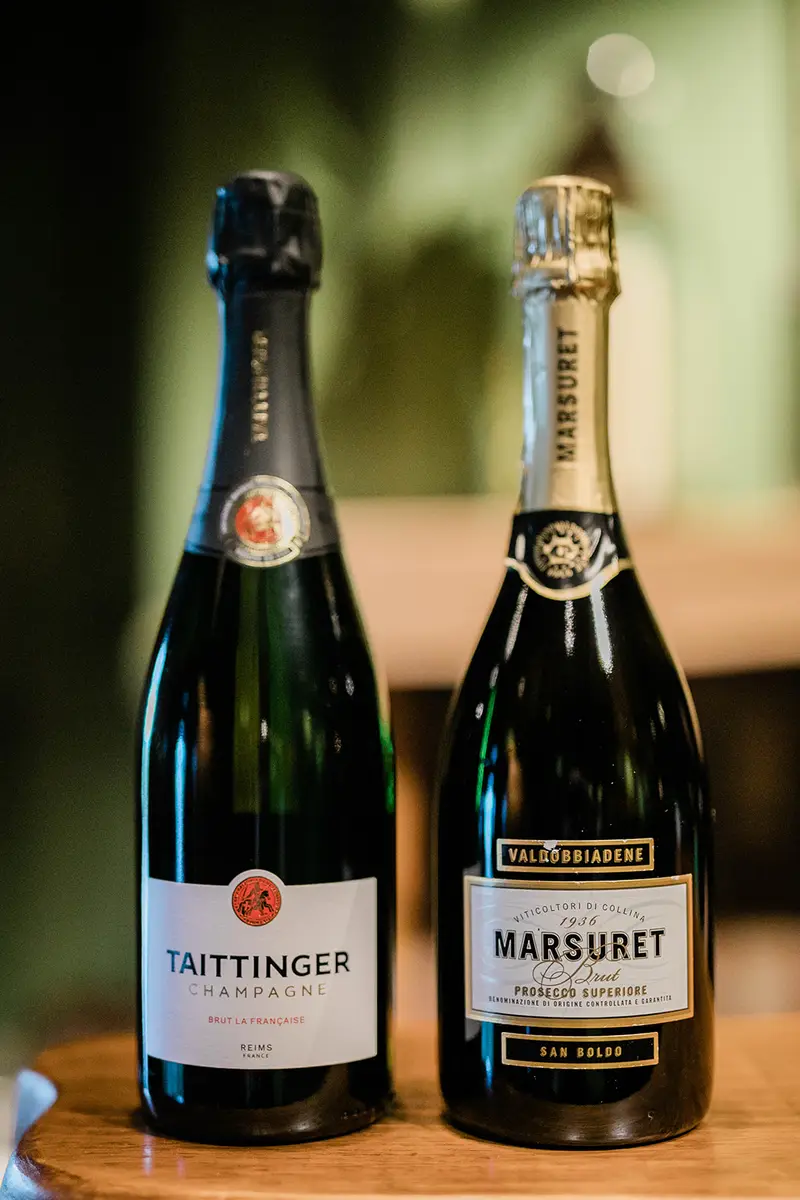Taittinger and Marsuret bottles at an event bar