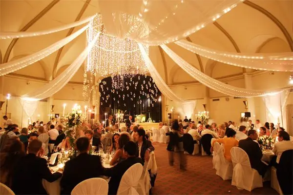 Guests seated at a banquet under string lights