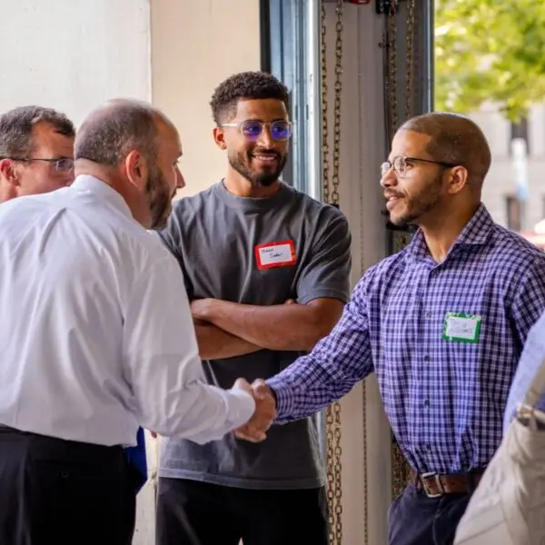 Guests shaking hands at the Making the City Smaller corporate event