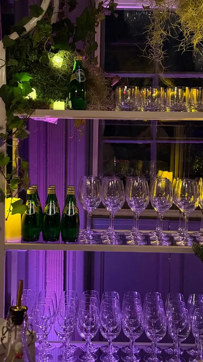 Bar shelving with glassware and Perrier bottles at a brand activation