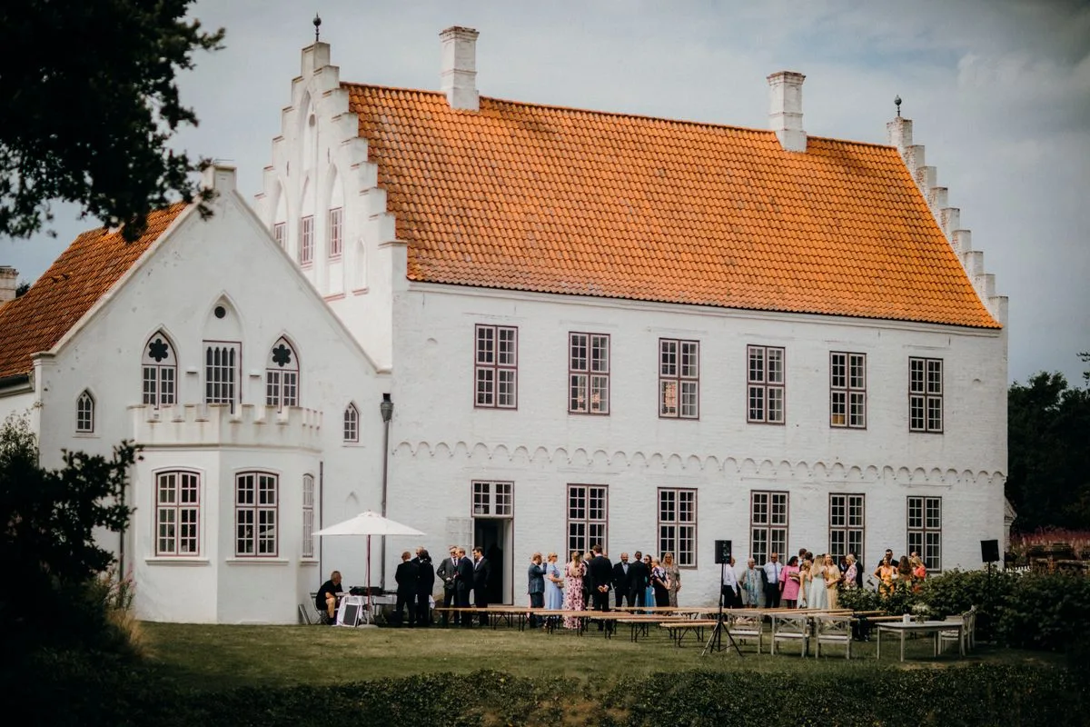 Guests outside a country hotel with a lawn
