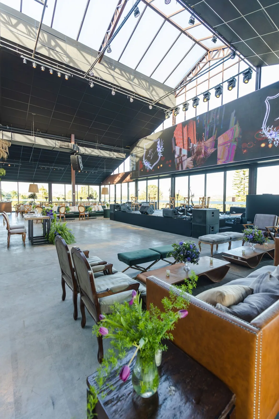 A spacious indoor event hall with tables and seating