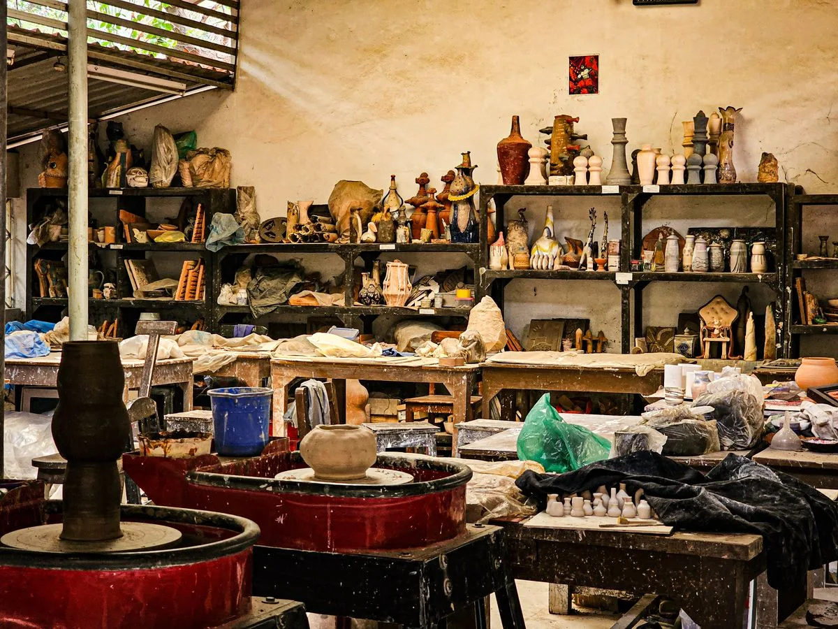 Shelves of pottery and tools inside a craft studio