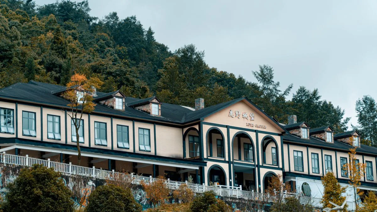 A hotel building surrounded by woodland