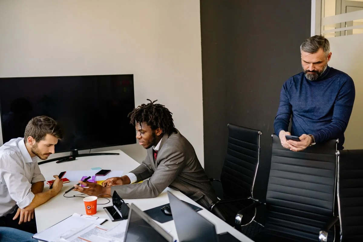 Colleagues discussing work around a conference table