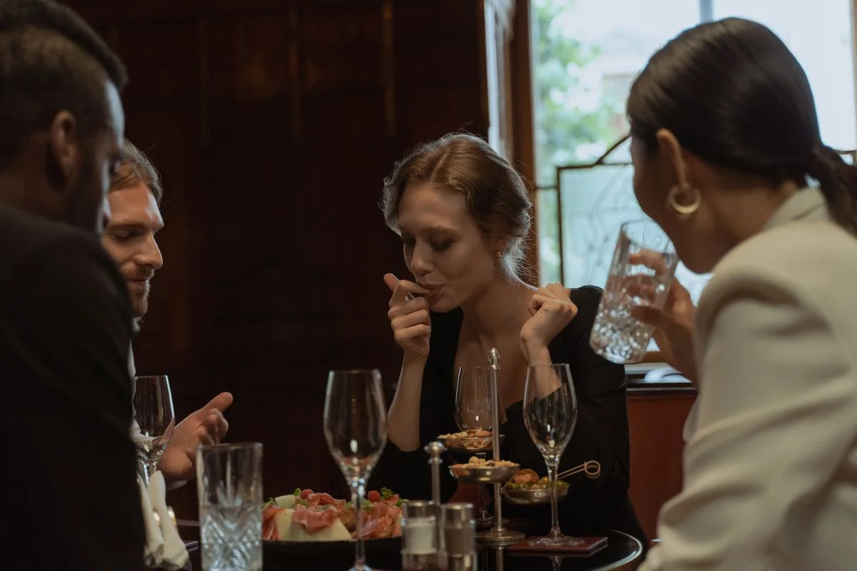 People sharing dinner and conversation at a restaurant