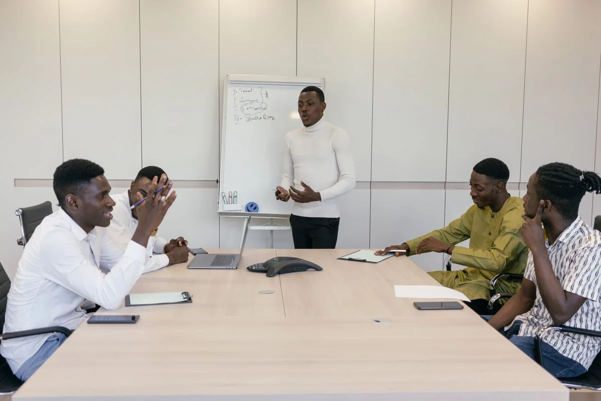 Colleagues sharing ideas around a workshop table
