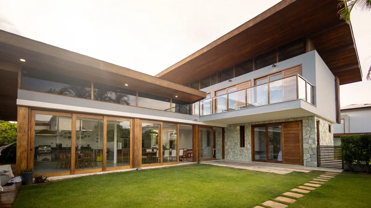 A contemporary retreat property with balconies beside a lawn