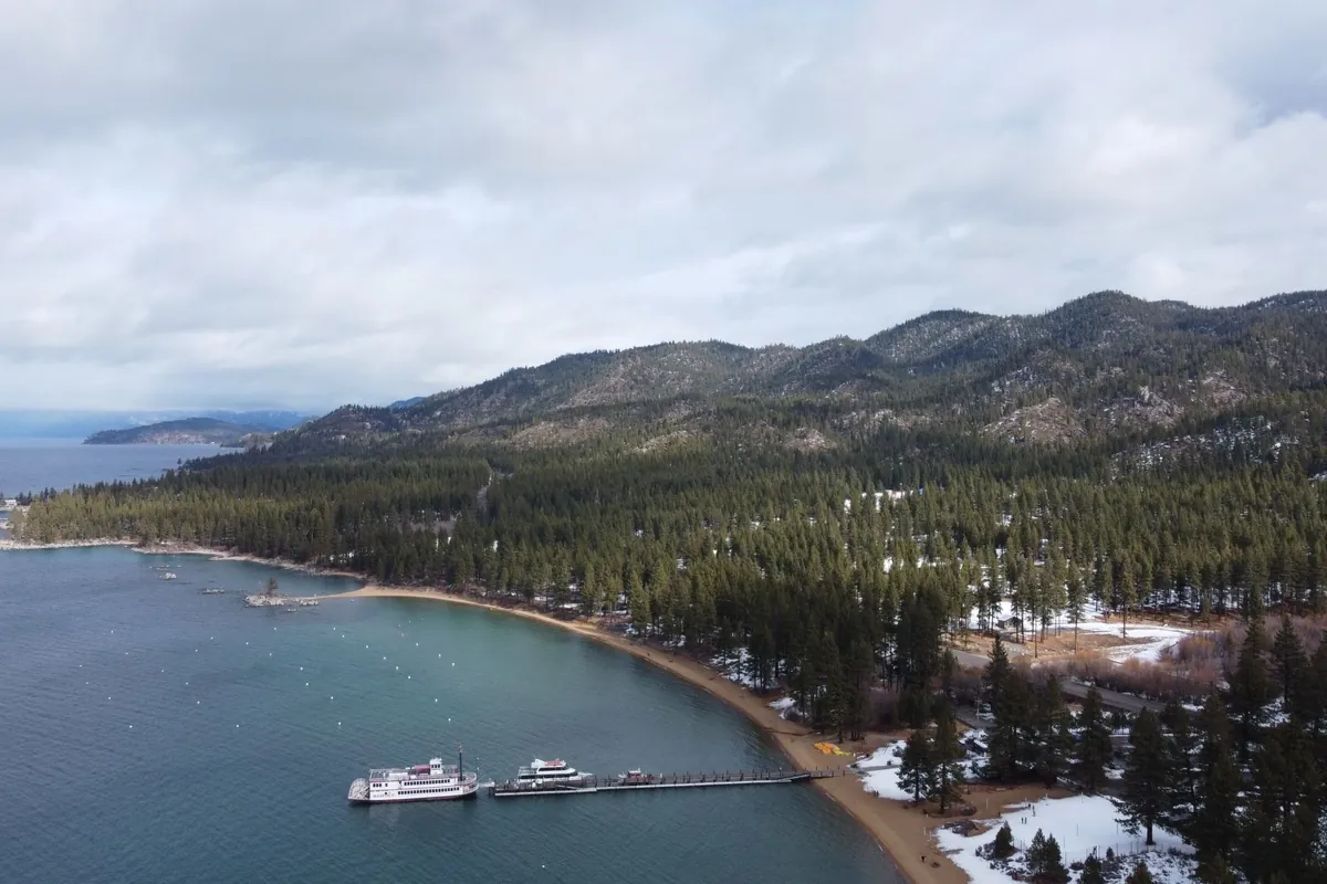 Snowy hills and forest along the Lake Tahoe shore at Glenbrook, Nevada.