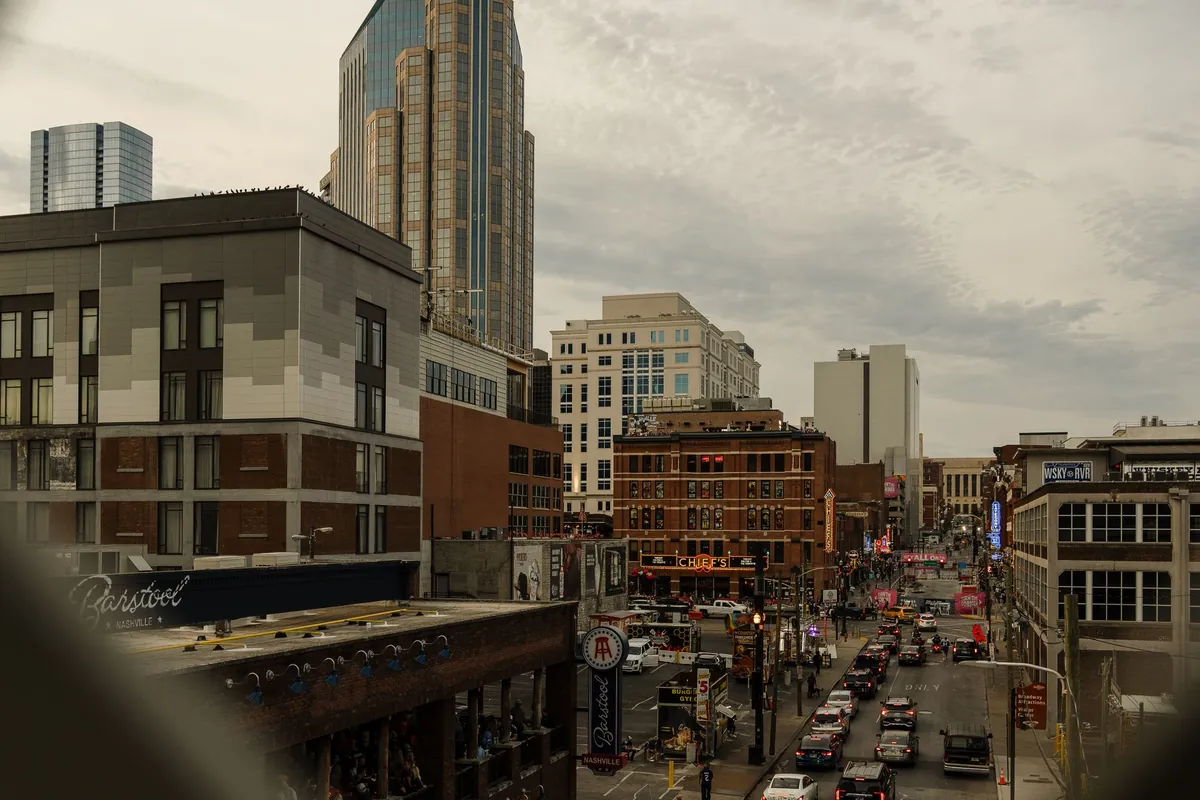 Downtown Nashville street below skyscrapers.