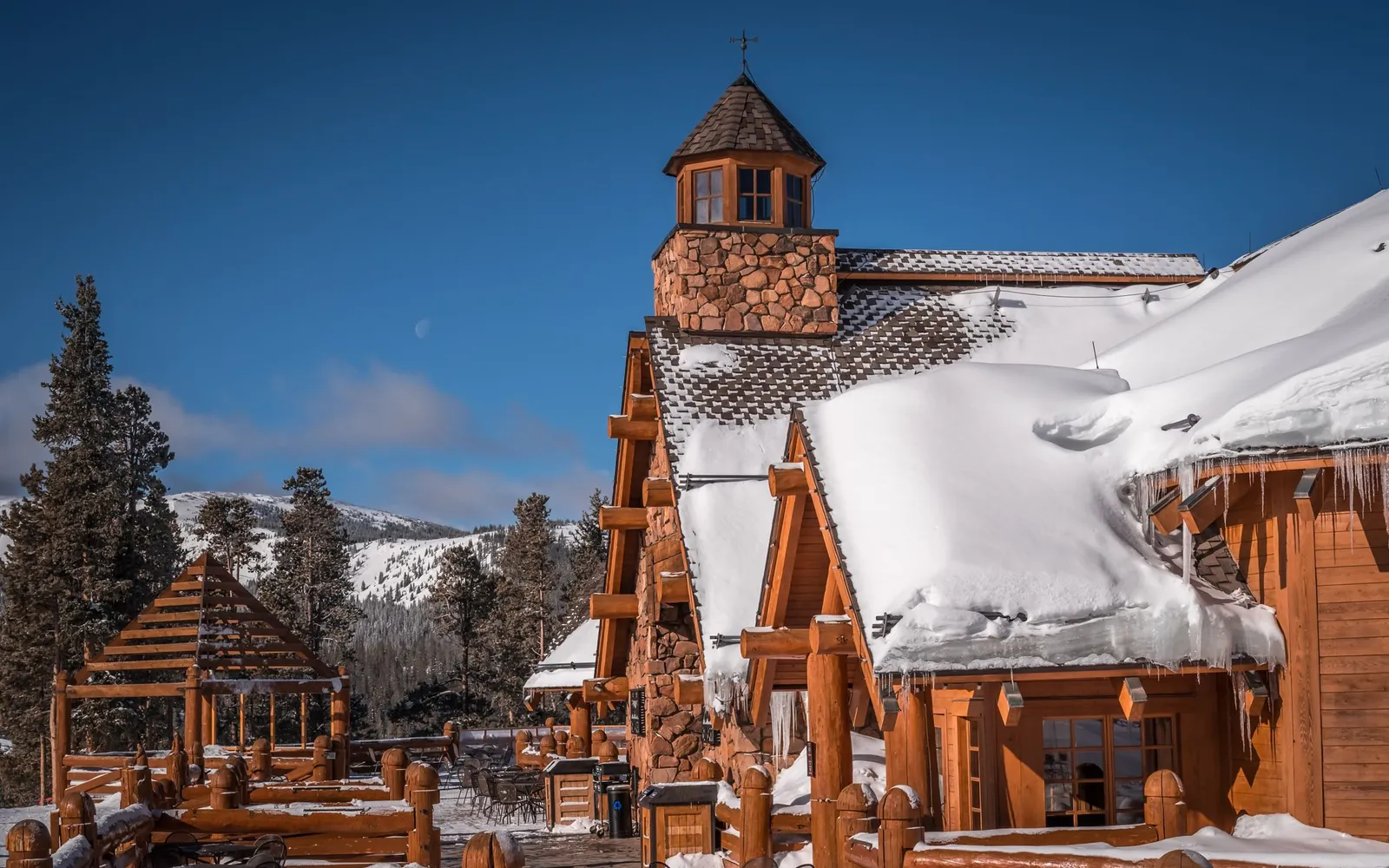 A snow-covered timber and stone lodge in the Colorado mountains.